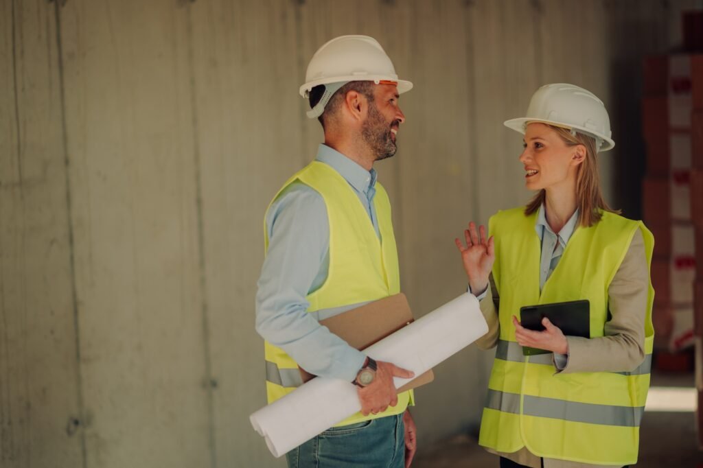 Engineers discussing building project inside unfinished building
